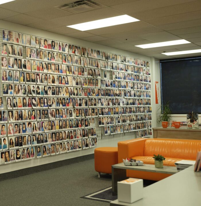 TMG's Salt Lake City office, with a wall of talent headshots